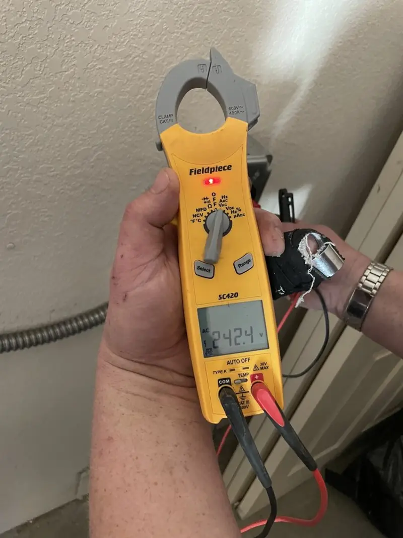 Voltage testing with clamp meter during Outlet Installation in Syracuse